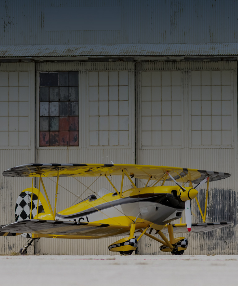 Great lakes plane in front of hangar