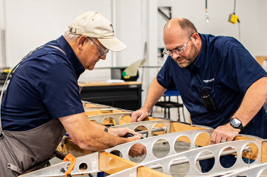 two WACO employees working on plane